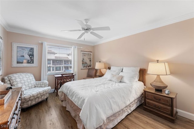 bedroom with ceiling fan, hardwood / wood-style flooring, and crown molding