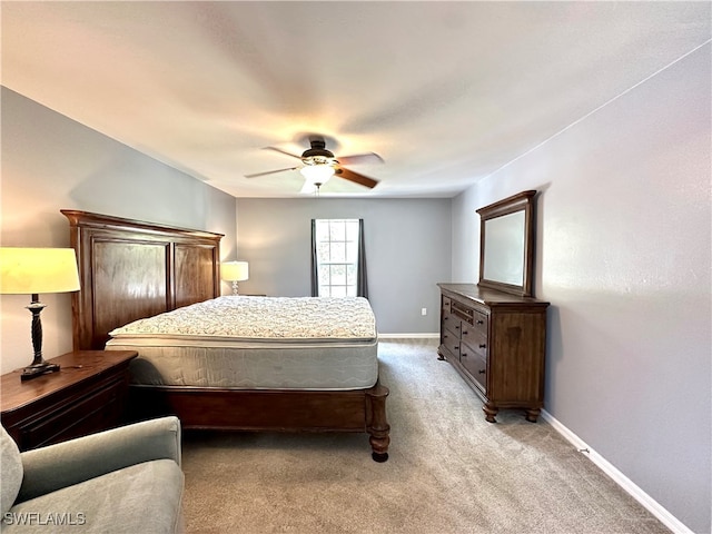 bedroom featuring ceiling fan and light carpet