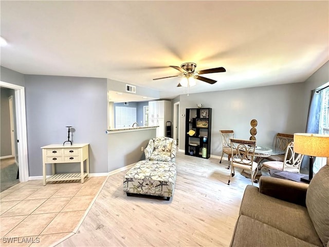 living room with ceiling fan and light wood-type flooring