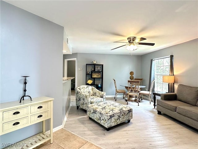 living room with light hardwood / wood-style floors and ceiling fan