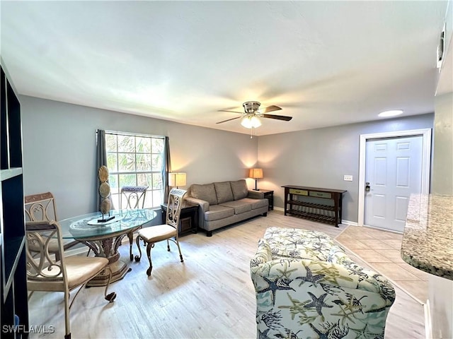 living room featuring light hardwood / wood-style flooring and ceiling fan