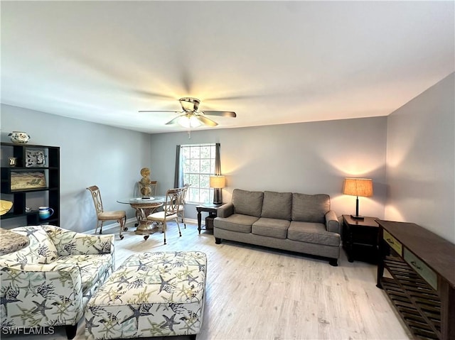 living room with ceiling fan and light hardwood / wood-style floors