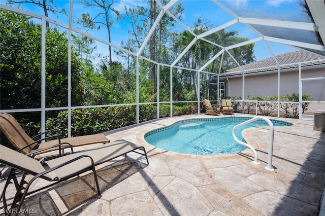 view of swimming pool featuring a lanai and a patio