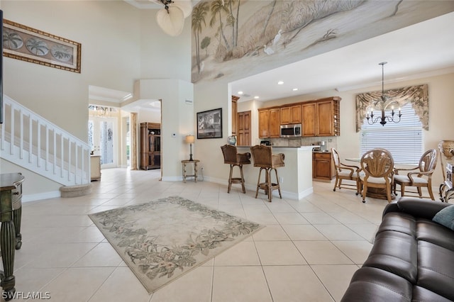 tiled living room featuring crown molding and a high ceiling