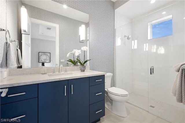 bathroom with toilet, vanity, tile patterned flooring, and walk in shower