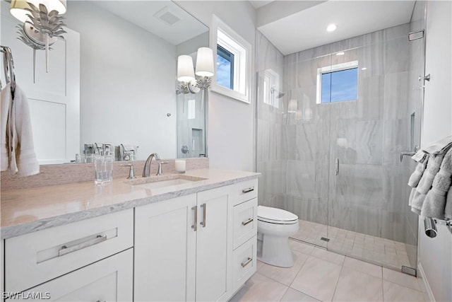 bathroom featuring toilet, tile patterned flooring, a shower with shower door, and vanity