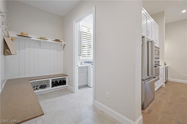 mudroom with independent washer and dryer