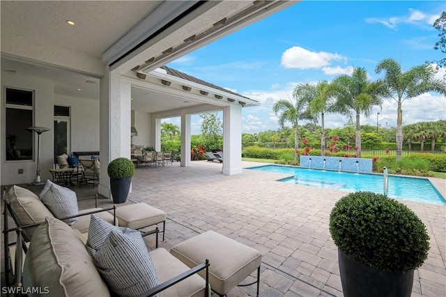 view of pool with pool water feature, a patio area, and outdoor lounge area