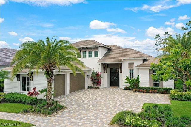 mediterranean / spanish home with a garage