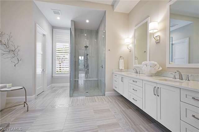 bathroom featuring walk in shower, vanity, and tile patterned floors