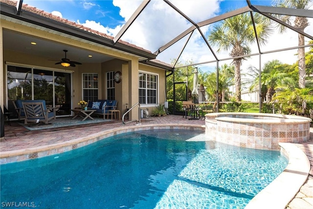 view of pool featuring a lanai, a patio area, ceiling fan, and an in ground hot tub