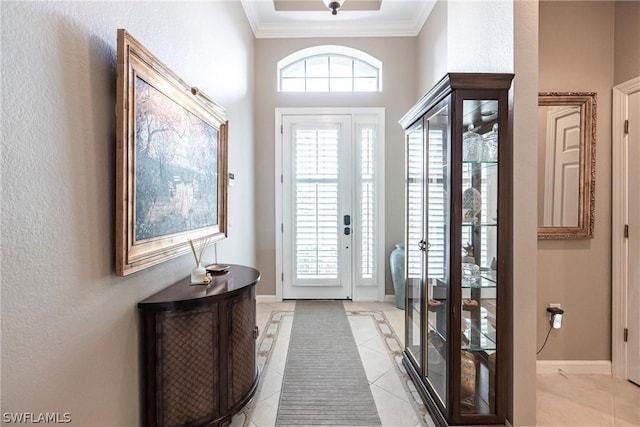 doorway with ornamental molding and light tile patterned floors