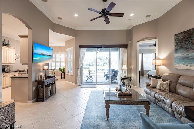 living room with crown molding, light tile patterned floors, and a wealth of natural light