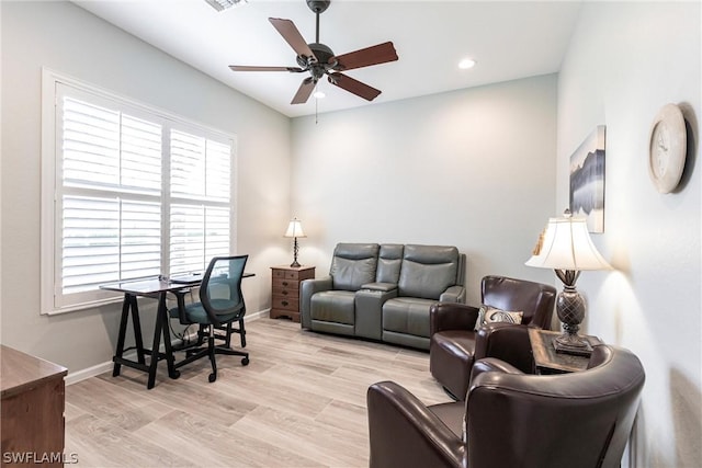 living room featuring ceiling fan and light wood-type flooring