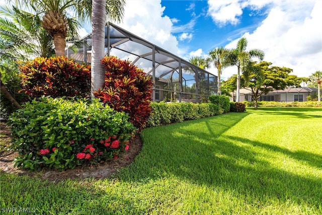 view of yard with glass enclosure