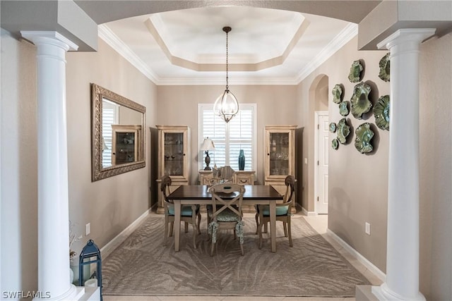 dining space with a notable chandelier, crown molding, and a raised ceiling