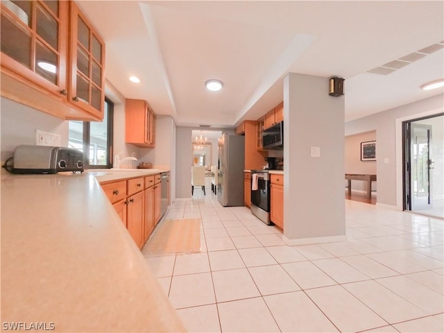 kitchen with light tile patterned flooring, sink, and appliances with stainless steel finishes