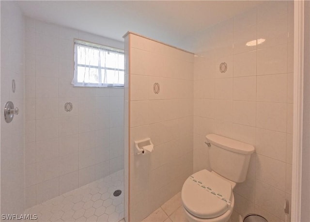 bathroom with tiled shower and toilet