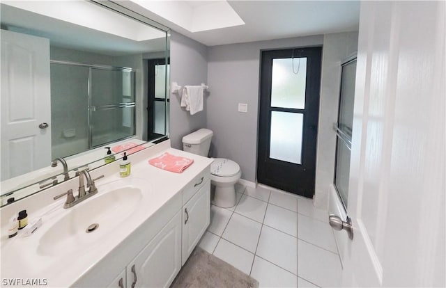 full bathroom featuring tile patterned flooring, vanity, toilet, and bath / shower combo with glass door