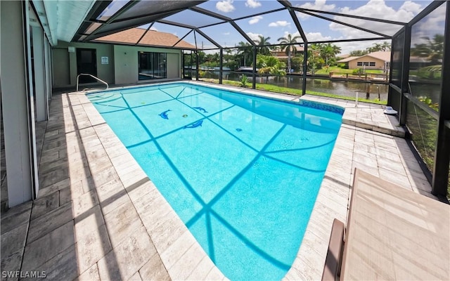 view of swimming pool featuring glass enclosure, a patio area, and a water view