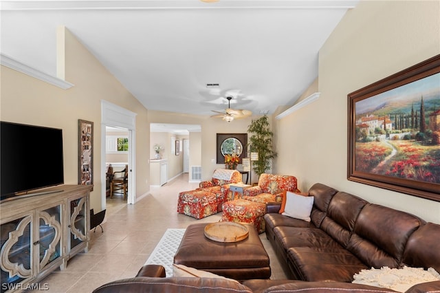 living room with ceiling fan, light tile patterned flooring, and vaulted ceiling