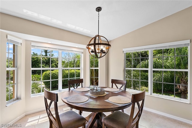 dining space with lofted ceiling, light tile patterned floors, and an inviting chandelier