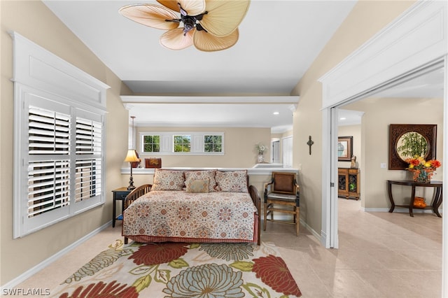 bedroom featuring light tile patterned flooring, baseboards, and ceiling fan