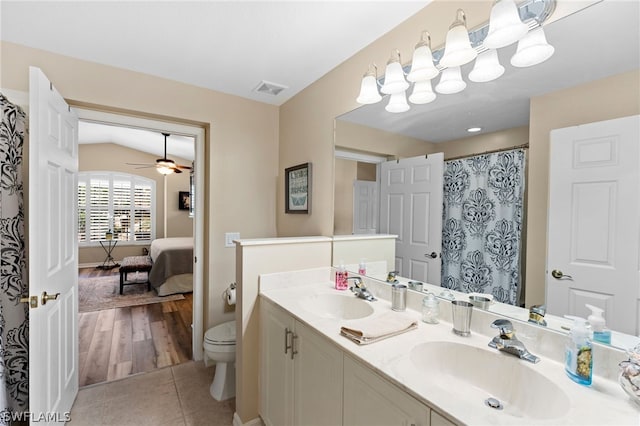 full bathroom with tile patterned flooring, double vanity, toilet, and a sink