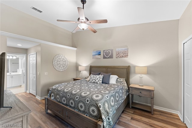 bedroom featuring a closet, ensuite bathroom, hardwood / wood-style floors, and ceiling fan