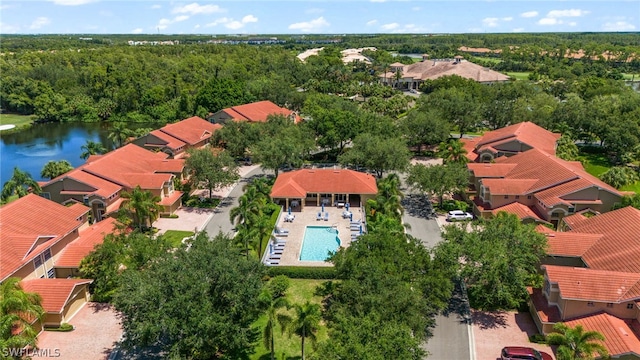 birds eye view of property with a view of trees, a water view, and a residential view