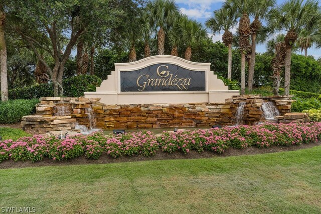 20331 Calice Ct Unit 1704, Estero, FL 33928 - community sign with a yard and view of scattered trees
