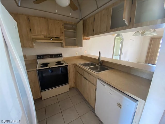 kitchen with sink, white appliances, ceiling fan, light tile patterned flooring, and light brown cabinetry