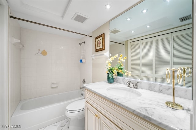 full bathroom with tile patterned flooring, vanity, tiled shower / bath combo, and toilet