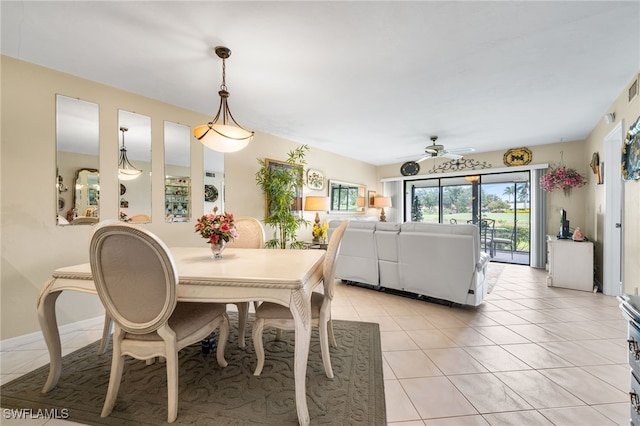 tiled dining area with ceiling fan