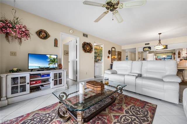 living room featuring ceiling fan and light tile patterned flooring