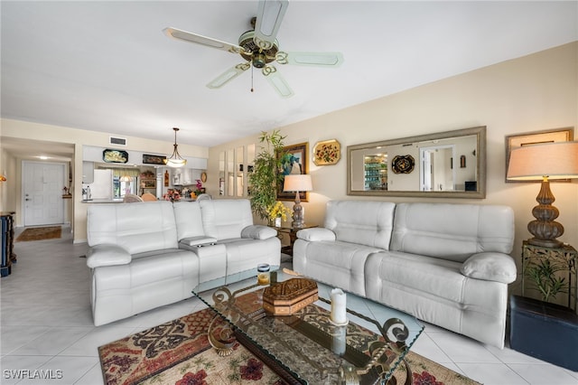 living room with ceiling fan and light tile patterned flooring