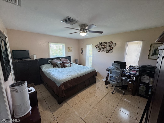 tiled bedroom featuring ceiling fan