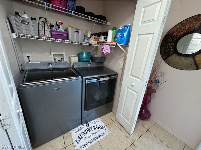 washroom with light tile patterned flooring and washing machine and dryer