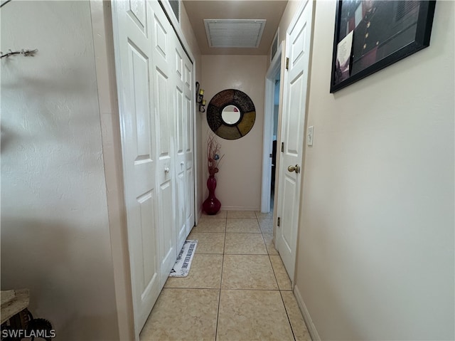 corridor with light tile patterned floors