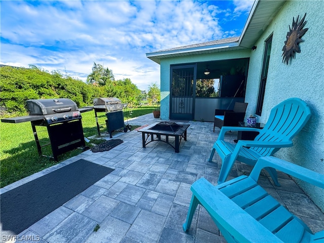 view of patio / terrace with grilling area and a fire pit