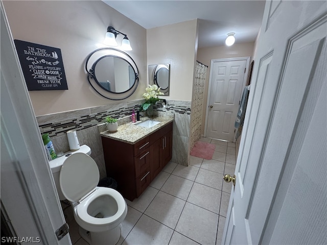 bathroom with decorative backsplash, tile patterned floors, toilet, and vanity