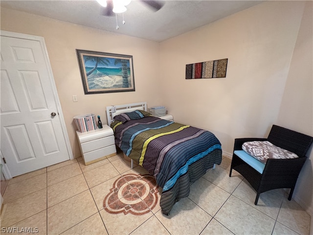 tiled bedroom with ceiling fan