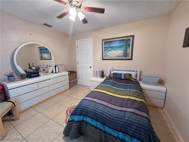 bedroom with light tile patterned flooring, a textured ceiling, and ceiling fan