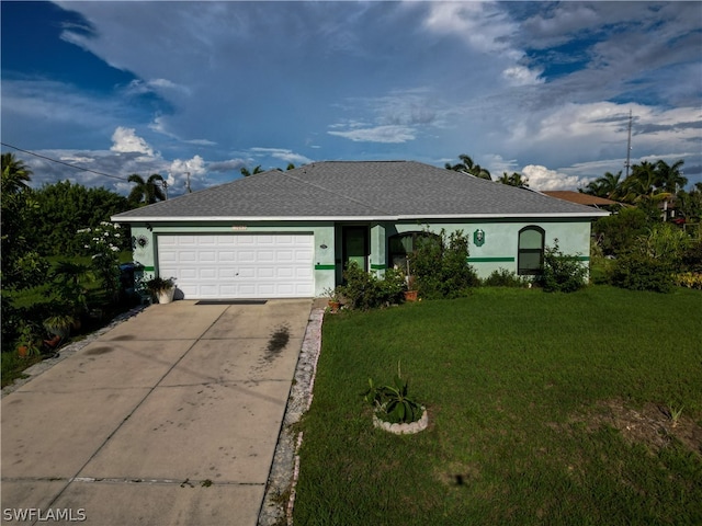 single story home featuring a garage and a front lawn