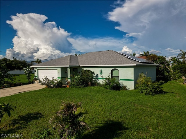 ranch-style home featuring a garage and a front yard