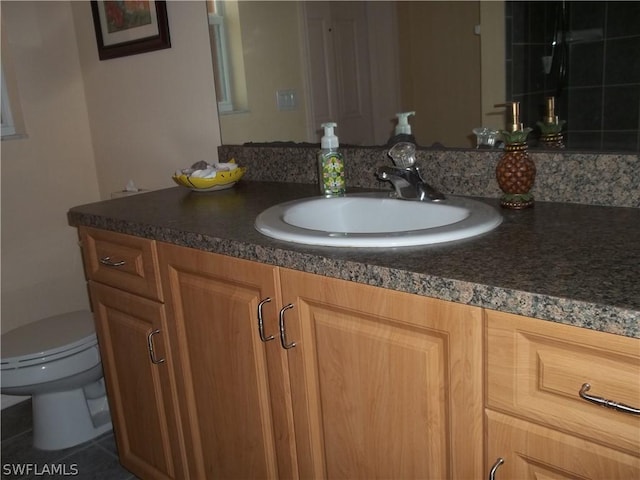 bathroom with vanity and toilet