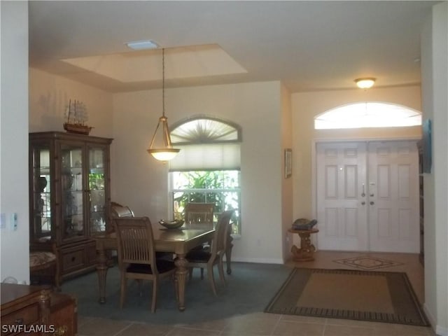 dining room with dark tile patterned flooring