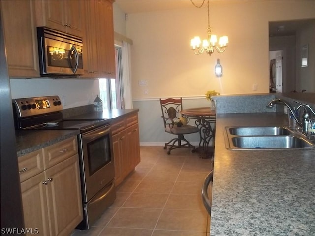 kitchen featuring sink, decorative light fixtures, light tile patterned floors, appliances with stainless steel finishes, and a notable chandelier