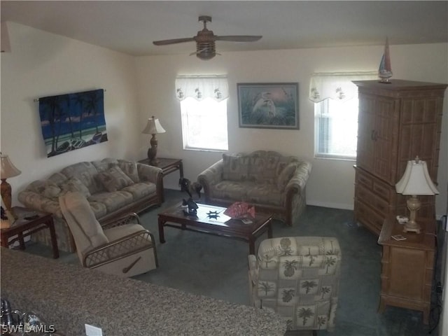 living room with ceiling fan, a healthy amount of sunlight, and dark carpet