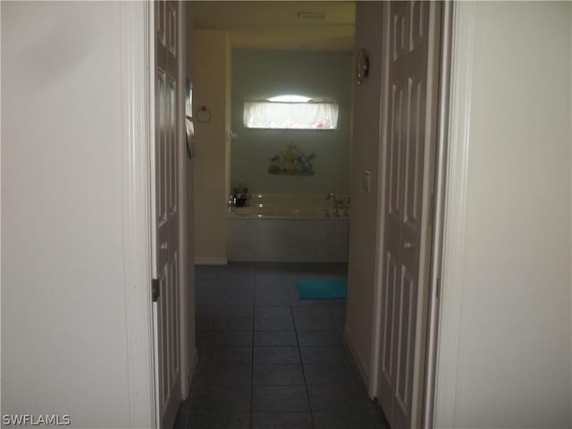 hallway featuring dark tile patterned flooring